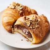 Warm 3-Ingredient Nutella Croissants, showing flaky layers and a rich, melted Nutella center, perfect for brunch.