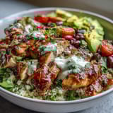 A vibrant 400-calorie burrito bowl with cilantro-lime cauliflower rice, lean chicken breast, and fresh toppings for a healthy, satisfying meal.  