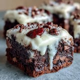 Festive 4th of July Firecracker Brownie Bites with creamy frosting and red, white, and blue sprinkles, perfect for Independence Day celebrations.