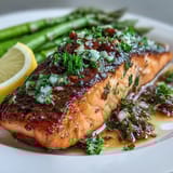 Aromatic garlic butter sauce coats tender salmon fillets and crisp asparagus spears in this easy, elegant dinner.
