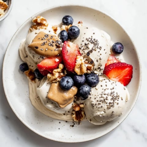 Creamy Protein Ice Cream Bowl, swirled to perfection, ready to be topped with fresh berries.