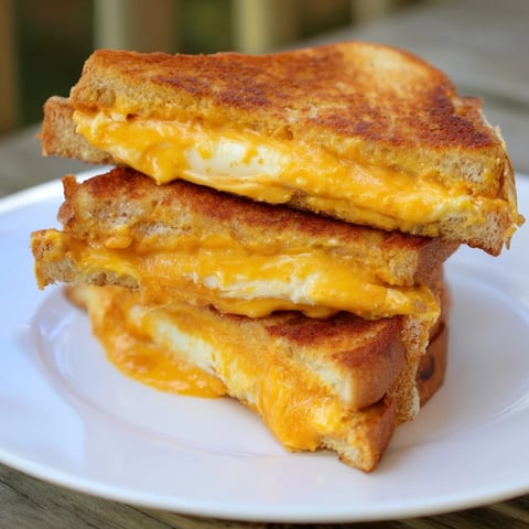 Golden, cheesy Honey Chipotle Butter Grilled Cheese, with melted cheddar and crispy sourdough crust.