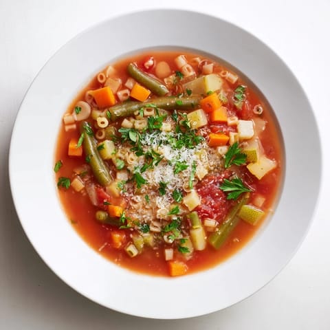 Vibrant image of a rich, homemade Simple One-Pot Minestrone Soup with tender vegetables and pasta.