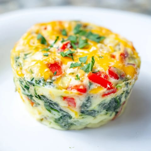 Golden-baked mini crustless quiches with spinach and herbs, served for a satisfying breakfast at home.