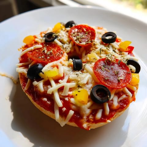 Cheesy mini bagel pizzas, air-fried to perfection, are piled with flavorful toppings.