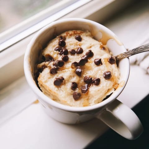 Steam rises from a single microwave mug pancake, ready for a quick and satisfying breakfast or snack.