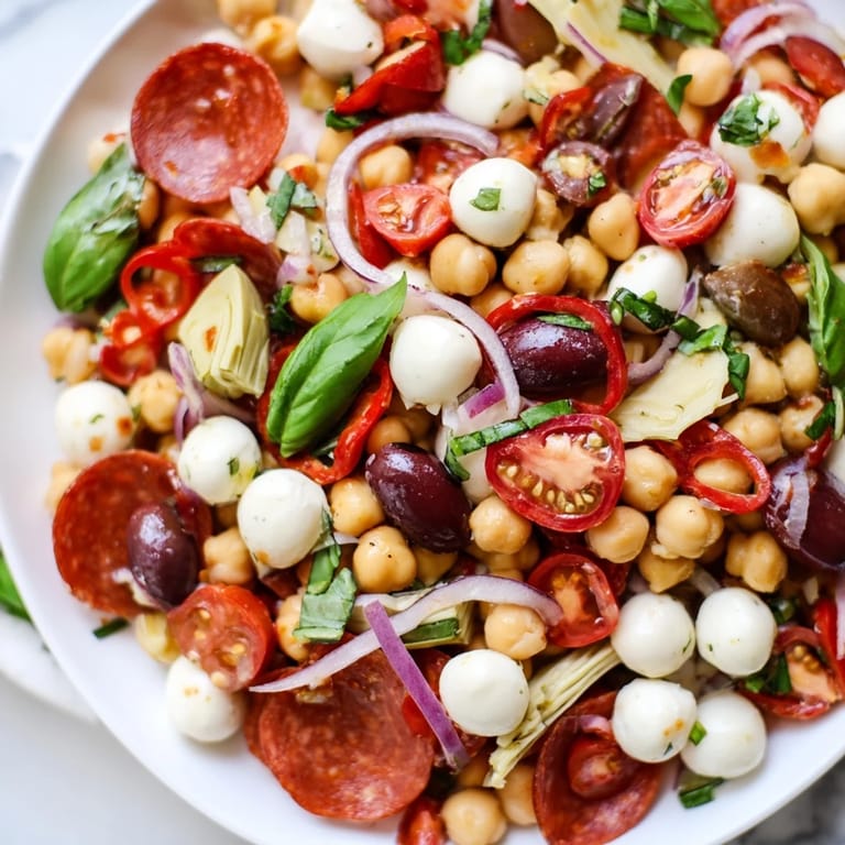 A close-up of a refreshing Antipasto Chickpea Salad, perfect for a light lunch or appetizer.