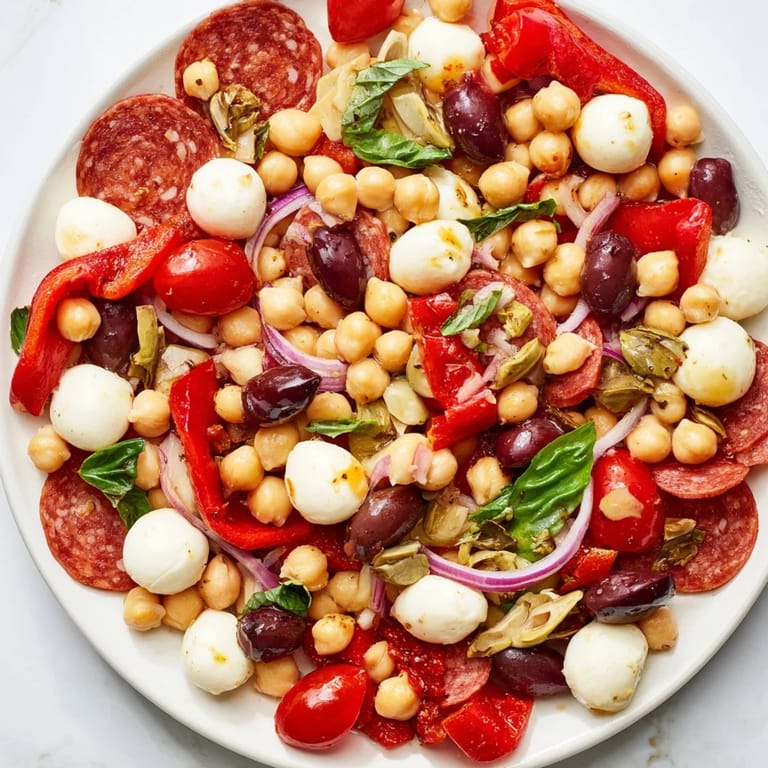 Tangy Italian dressing coats a flavorful Antipasto Chickpea Salad, ready to enjoy cold and fresh.