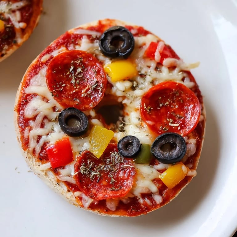 Close-up of bubbling mozzarella on mini bagel pizzas, perfect for a quick and easy appetizer.