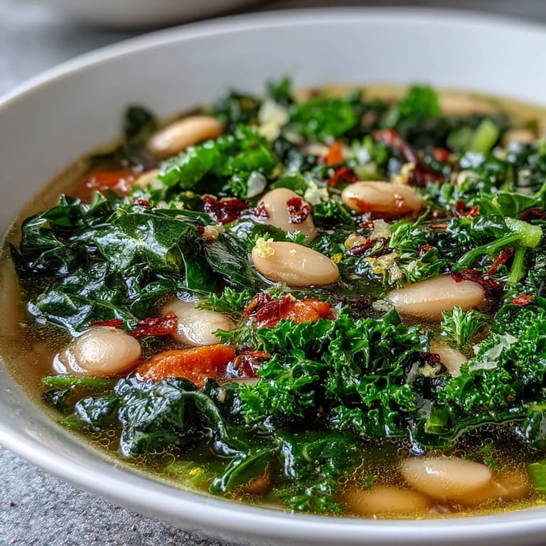 Hearty white beans and tender kale in a fragrant broth with bright lemon and garlic aroma.  