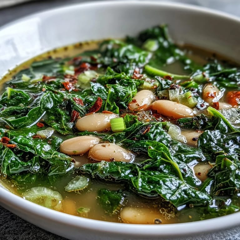 Cozy, nourishing kale and white bean soup with zesty lemon and savory garlic, perfect for lunch.