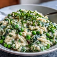 A creamy, vibrant risotto with sweet spring peas, fresh mint, and Parmesan—perfect for a light vegetarian dinner.  