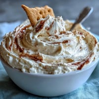 Creamy 3-ingredient cheesecake dip served with crunchy graham crackers, perfect for parties and snacking.