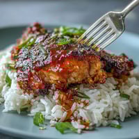 Honey Garlic Chicken with Rice - Crockpot honey garlic chicken thighs in a sweet and savory sauce served over fluffy jasmine rice.