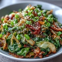 Vibrant Spicy Cabbage Stir Fry glistening with chili and sesame oil.